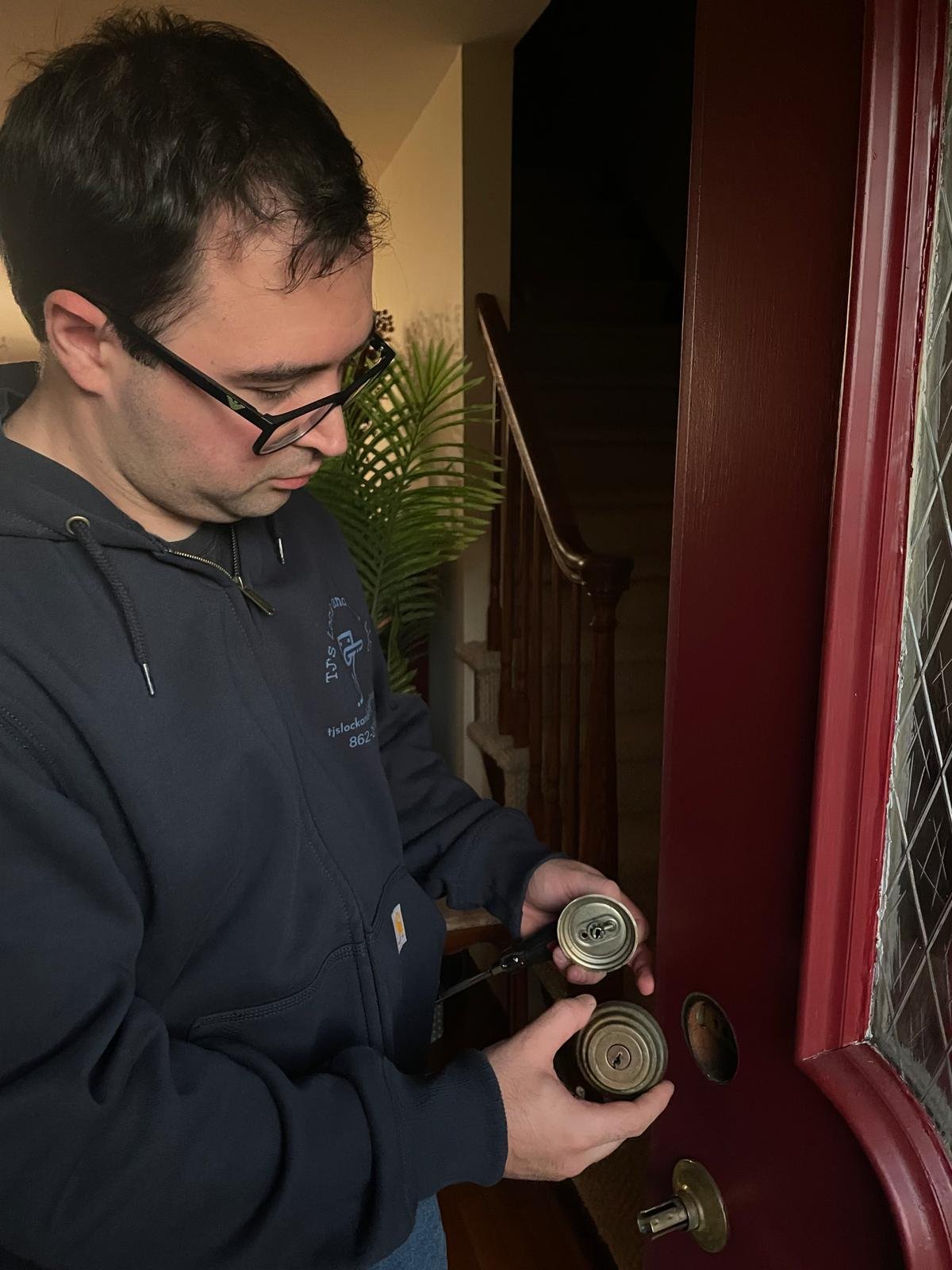 Professional locksmith installing a door lock